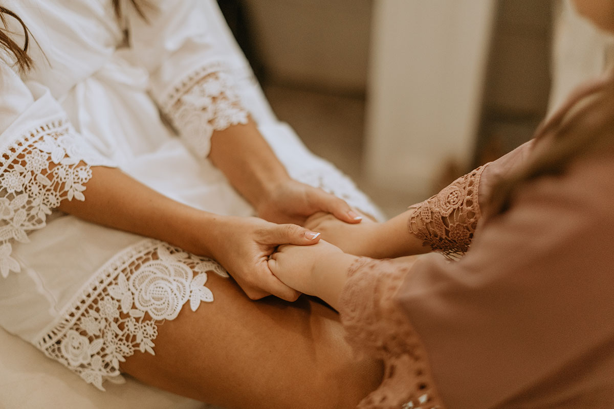 Bride and flower girl holding hands