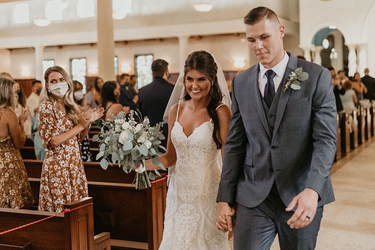 Madi and husband walking down aisle